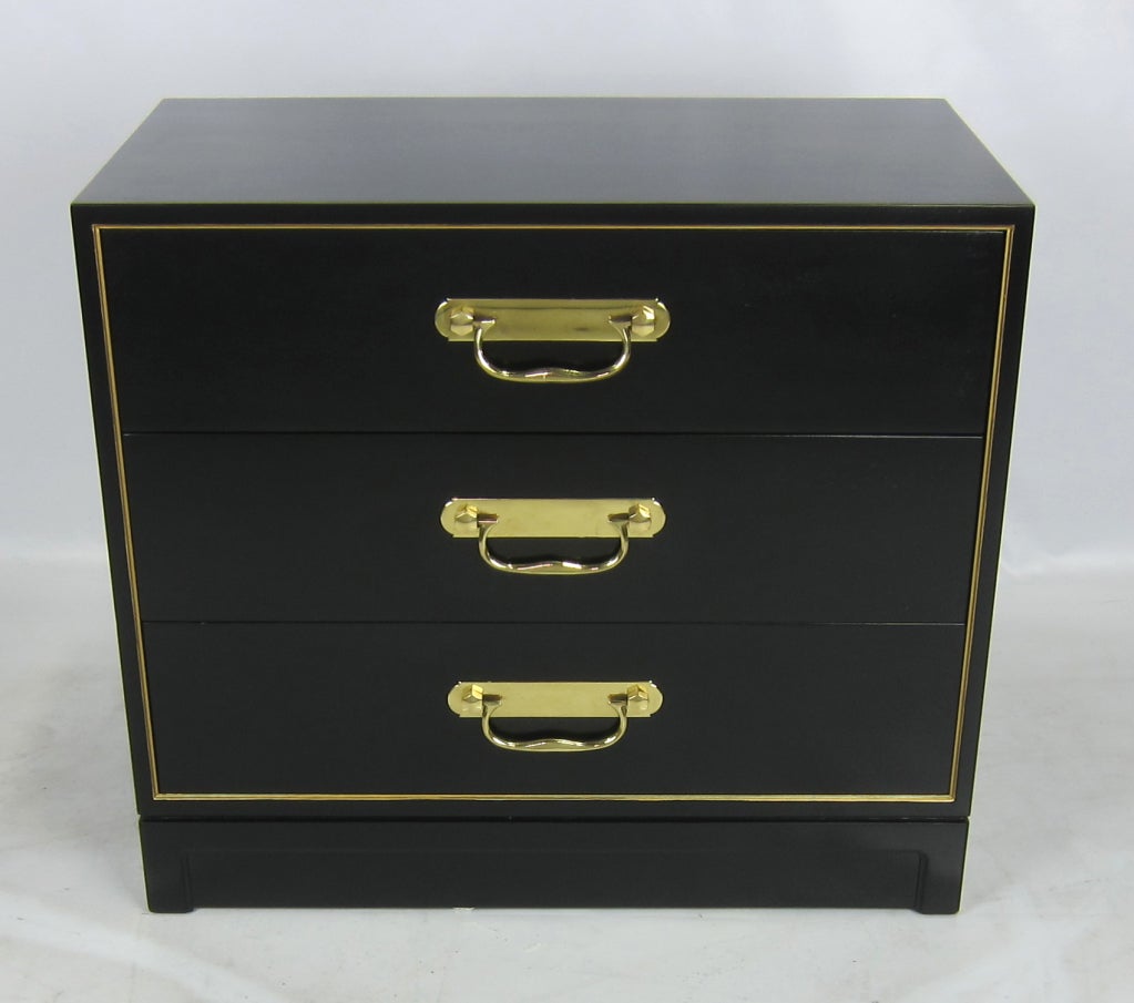 Pair of mahogany bachelor's chests with gilt trim and polished brass drop handles.