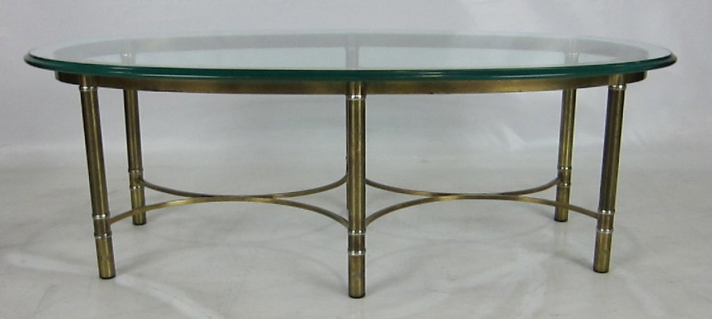 Brass Oval Coffee Table with curved stretchers.  Please see our complete inventory at www.antiquesdumonde.1stdibs.com.