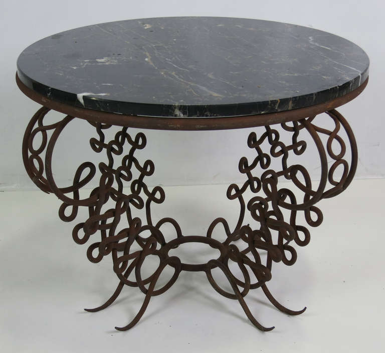 Wonderful and Whimsical Side Table that would be the epitome of the Ironworker's craft.  Four looping and sinuous legs supporting a Nero Portoro Marble top.  The base and top have been left in their as-found condition.  The base is beautifully aged