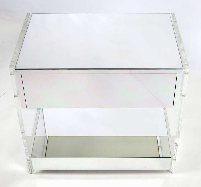 Sleek pair of 70's Chrome Laminate and Lucite Night Stands.  The chrome cased drawer and under-shelf float within two 1