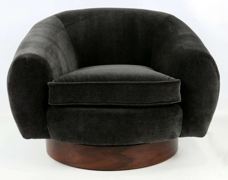 Pair of Velvet Swivel Chairs in the style of Jean Royere's Polar Bear chairs.  The pair swivel on Rosewood veneer swivel bases.  