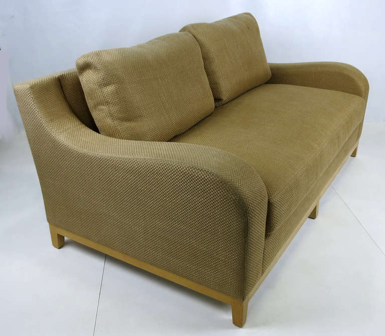 Sculptural sofa by Christian Liaigre for Holly Hunt. The sofa is raised on a solid oak base.