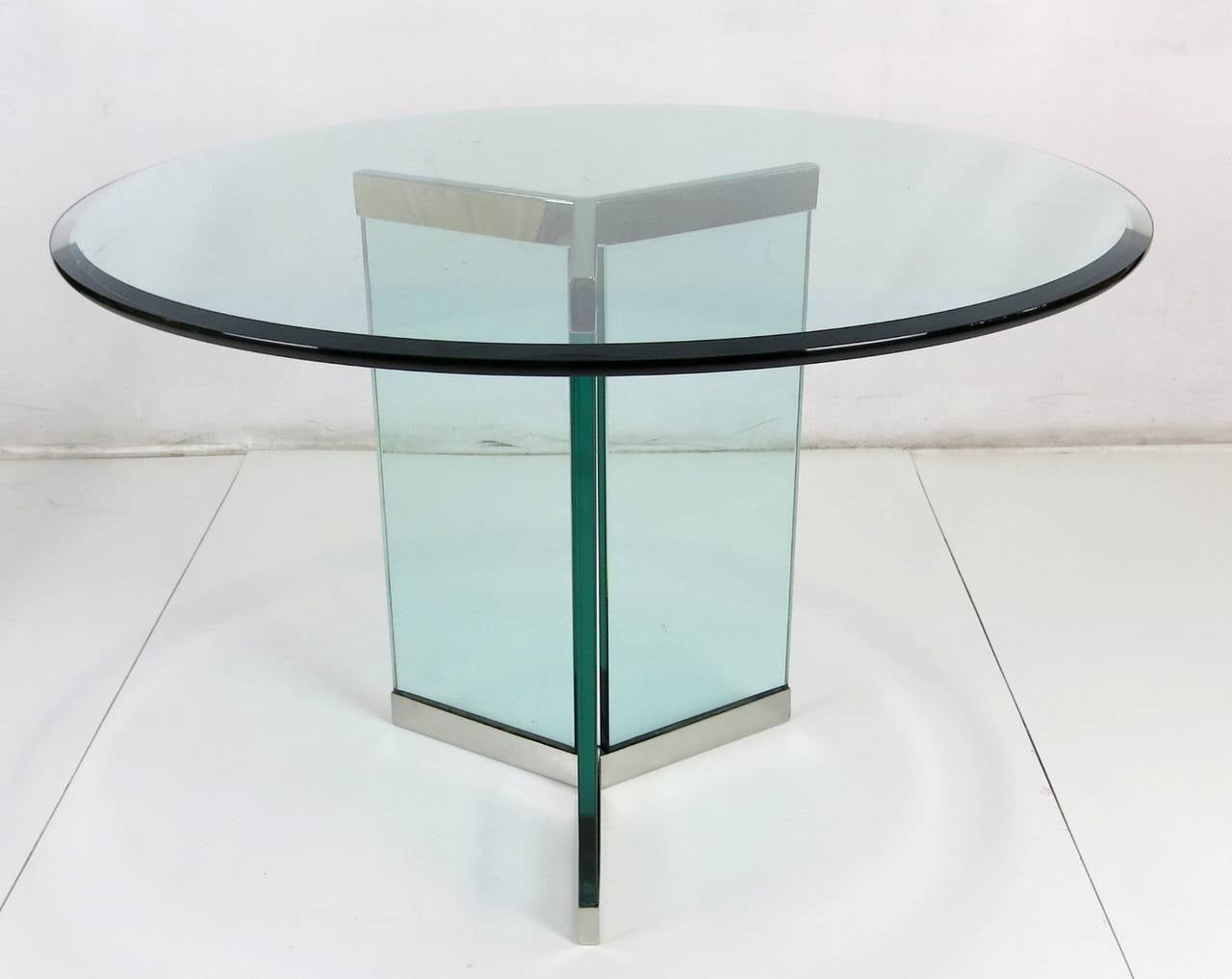 Pair of delta form table bases in mirror polished stainless steel fixtures holding sheets of 3/4