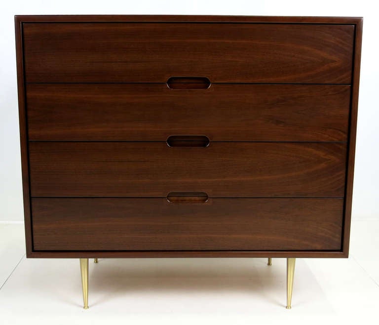 Walnut chest of drawers with bookmatched grain Walnut drawer and cabinet in the style of Edward Wormley for Dunbar.  Solid brass tapered legs.  Meticulously refinished in dark brown open grain lacquer.