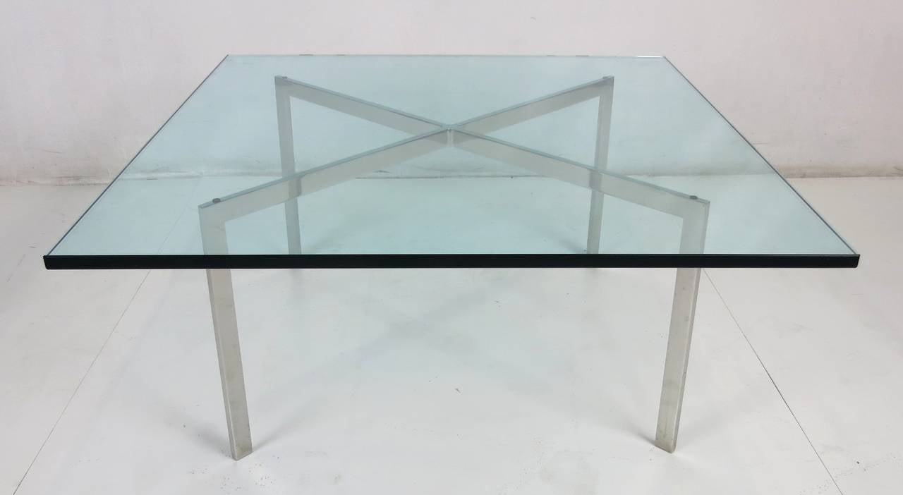 Early stainless steel Barcelona table by Ludwig Mies van der Rohe for Knoll. The table frame is in excellent vintage condition and the glass has wear commensurate with its age. Stamped 