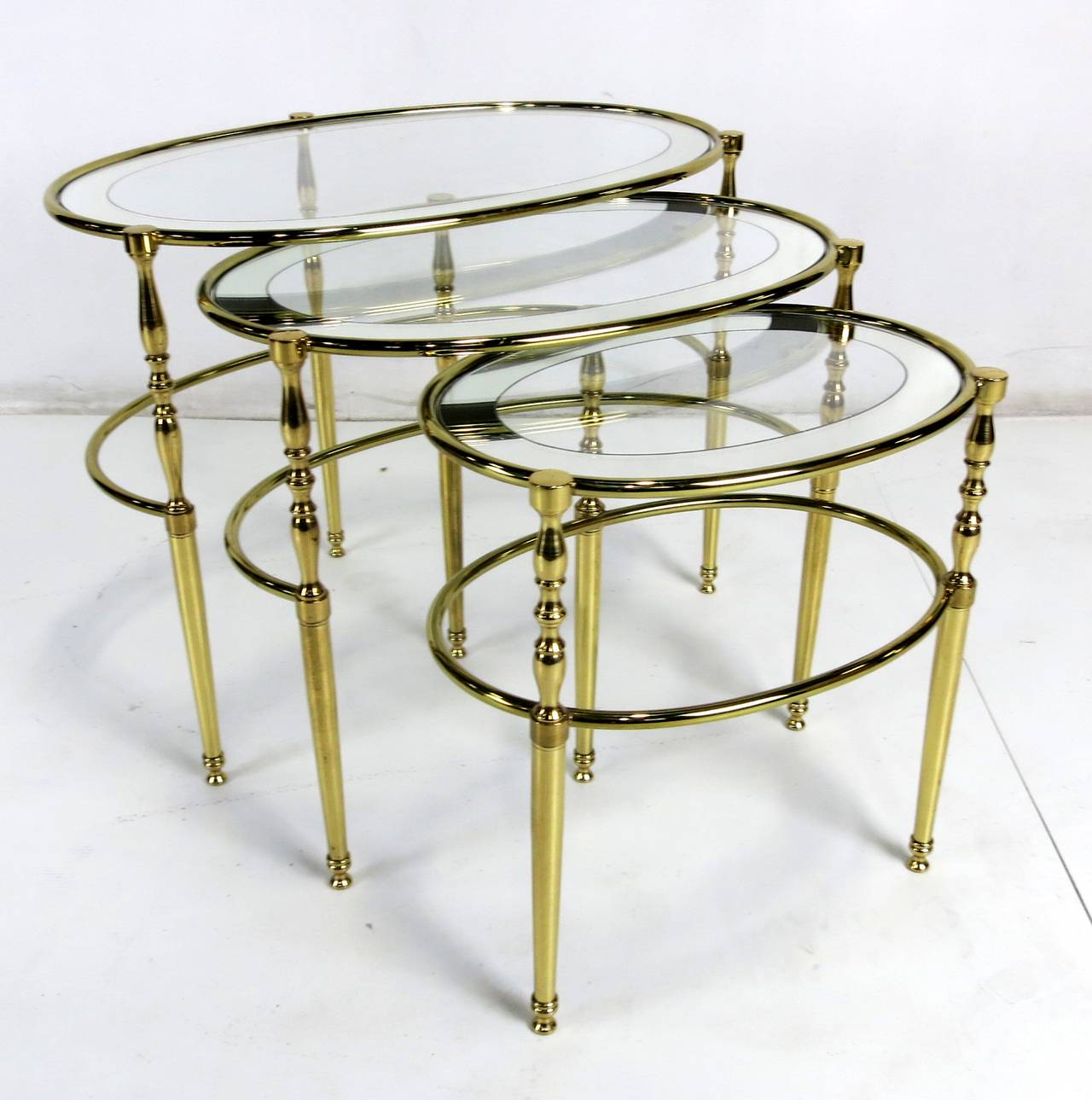 Gorgeous set of three brass Chiavarine nesting tables with mirror bordered glass tops. 

Dimensions:
Large: 25 x 16 x 19.
Medium: 20.5 x 14 x 18.
Small: 16 x 11 x 17.