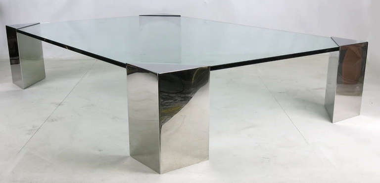 Immense Coffee Table consisting of four mirror polished stainless steel corner fixtures supporting a 3/4