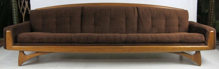Fantastic sofa with open walnut frame in the style of Adrian Pearsall. COM upholstery available. Three available.