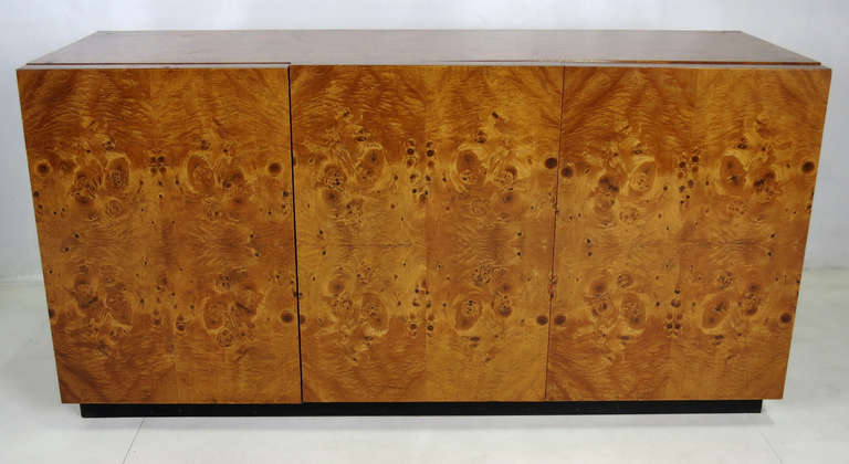 Beautiful Olive Burl Cabinet raised on black laminate plinth base attributed to Pierre Cardin for Dillingham.  One side has a drawer and an adjustable height shelf and the other has a single adjustable height shelf.