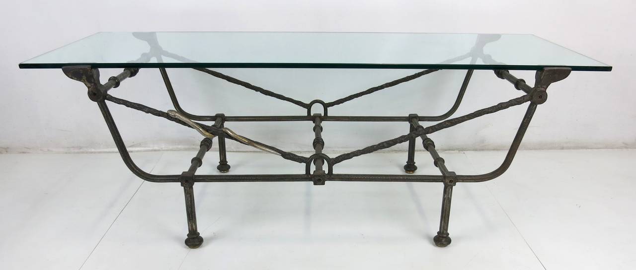 Wonderful coffee table of wrought and cast iron in the style of Giacometti with a whimsical bronze snake climbing the frame (removable if desired). Adjustable height bronze glides.