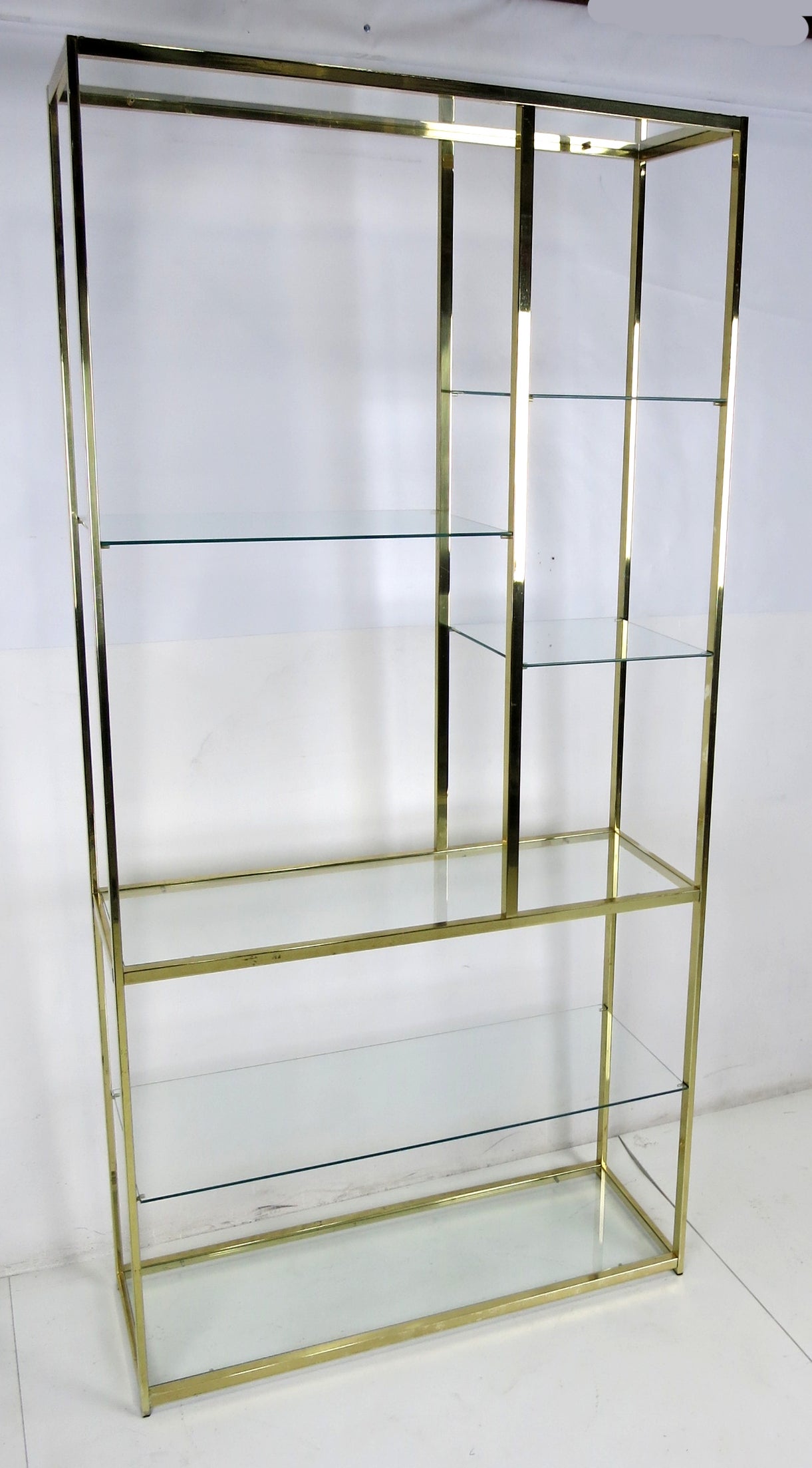 Handsome brass etagere with glass shelves.