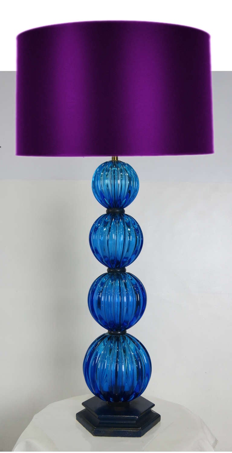 Spectacular and large scale Table Lamp consisting of four ribbed blue glass spheres (the largest being 7