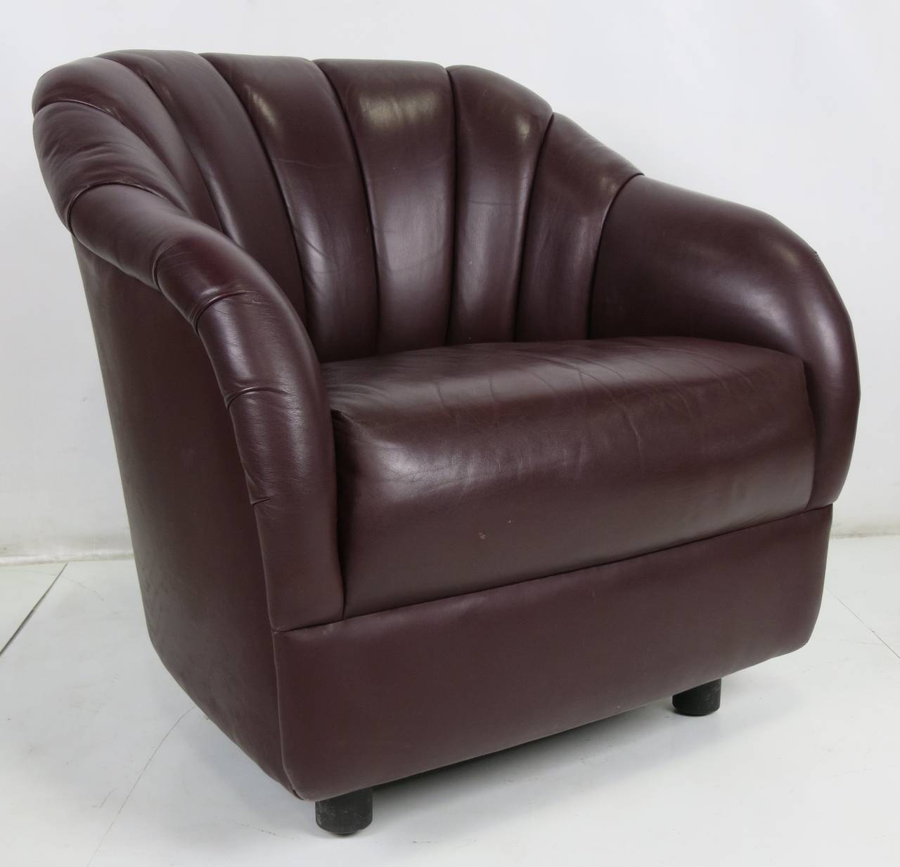 Handsome pair of leather lounge chairs by Ward Bennett for Brickel Associates. The pair are upholstered in a deep burgundy or brown leather and are in excellent original condition. When new, this model was offered with an optional swivel base. We