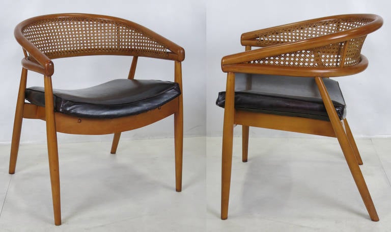Pair of dramatic round backed Lounge Chairs most famously used by James Mont in one of his most notable commissions, the King Cole Penthouse in Miami.  They feature a beautiful hand-woven cane seatback.  The pair are in excellent original condition.