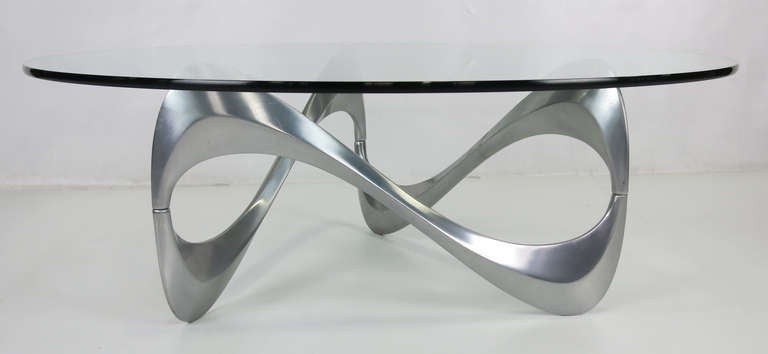 Ribbon form Coffee Table by Knut Hesterberg for Joseph Schmidt.  The cast and polished aluminum freeform base is shown with a 42