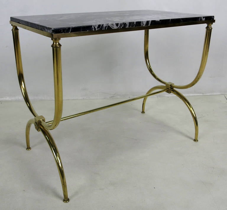 Curule form Brass Table with beautifully figured Black marble top.