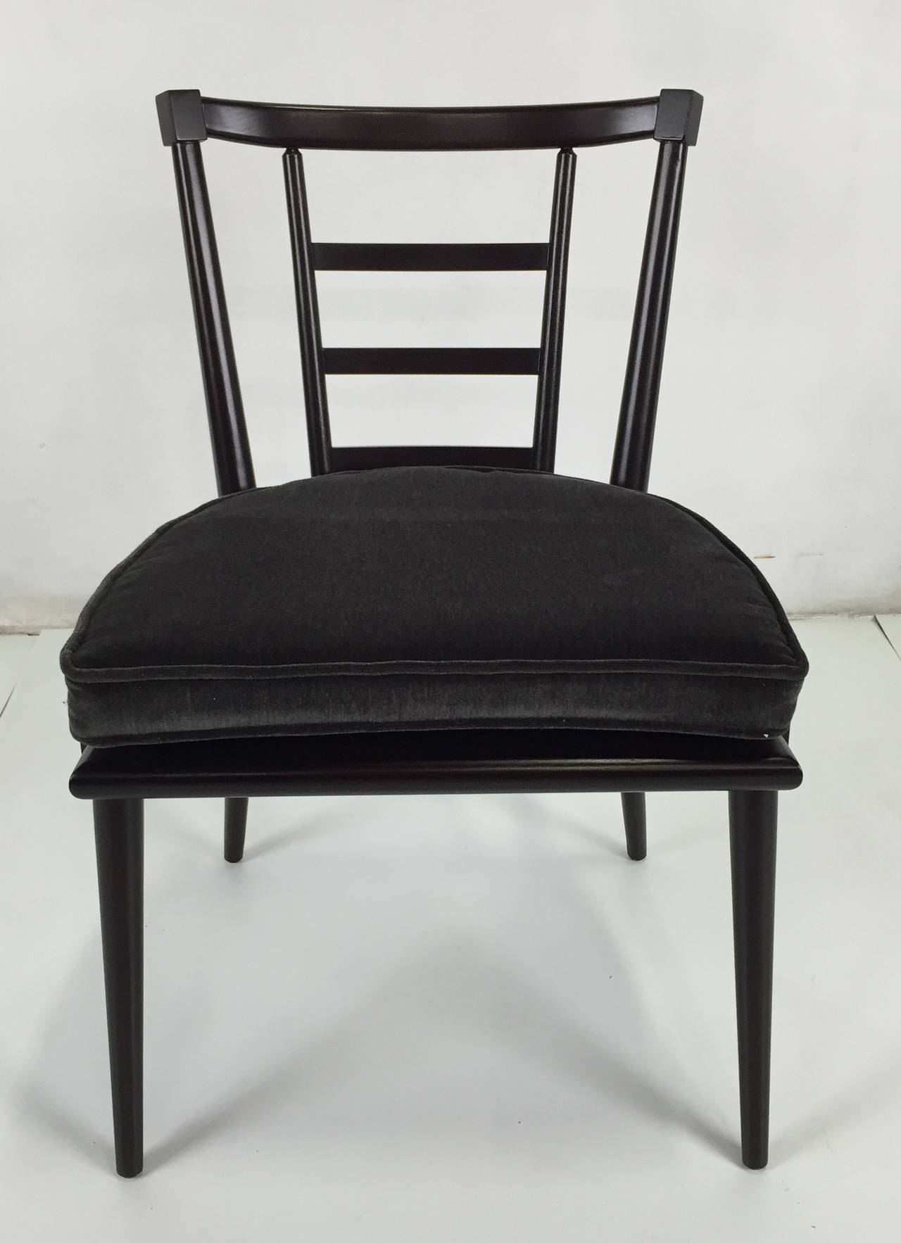 Set of six dining chairs by Bert England for Johnson furniture. The set consists of two Armchairs and four side chairs. The set has been painstakingly refinished in dark brown lacquer and are presented in perfect condition. Cushions have been