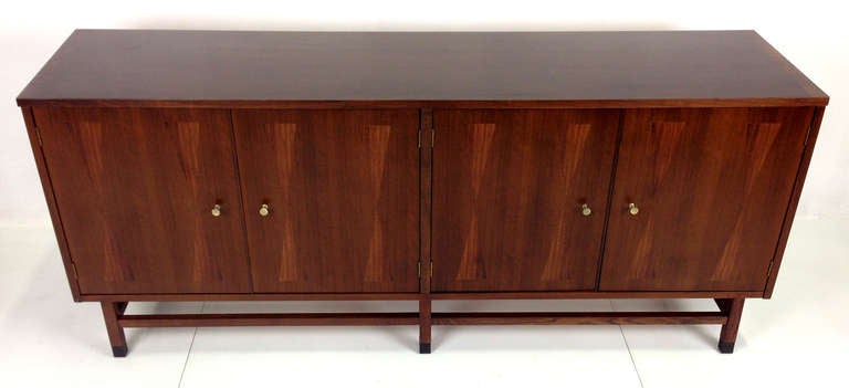 Fantastic Walnut Buffet with Rosewood hourglass inlaid doors and leather sabots.  The left side of the cabinet has an adjustable shelf and the right side has four pull outs with the top drawer being divided for storage.  Please contact us directly