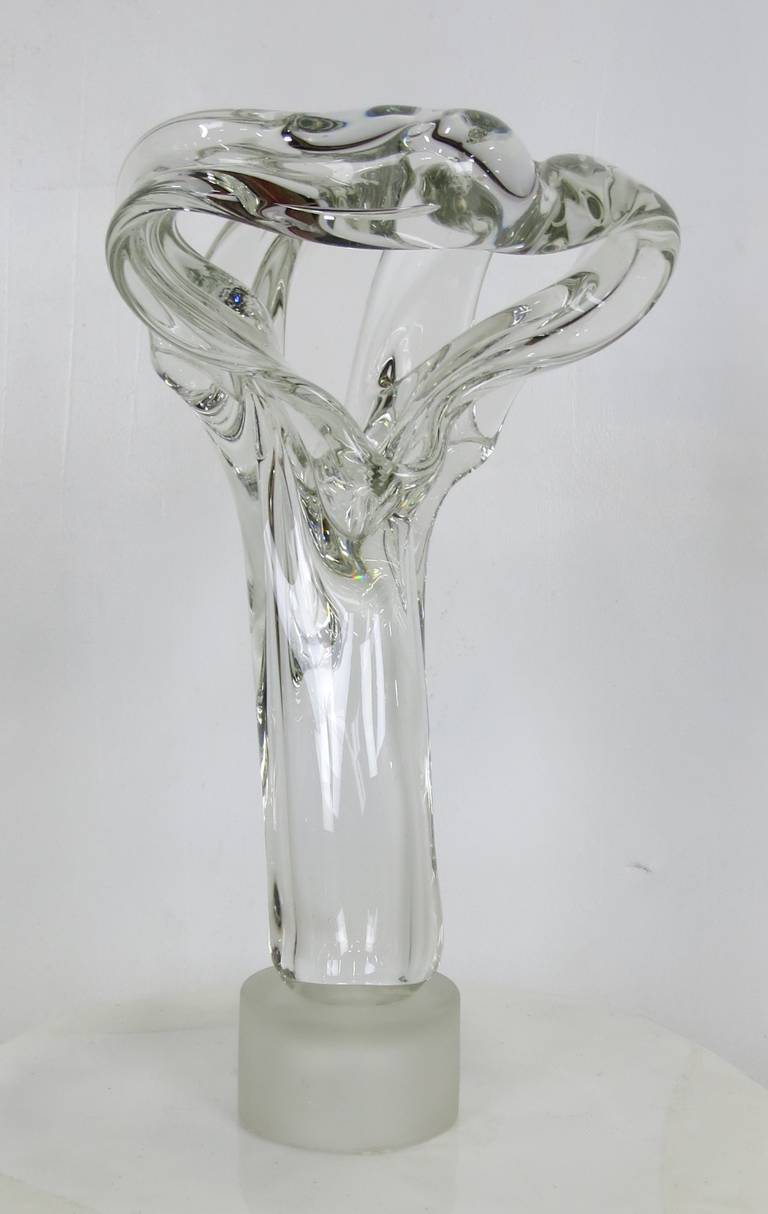 Large free-form glass sculpture mounted on a sandblasted glass plinth.