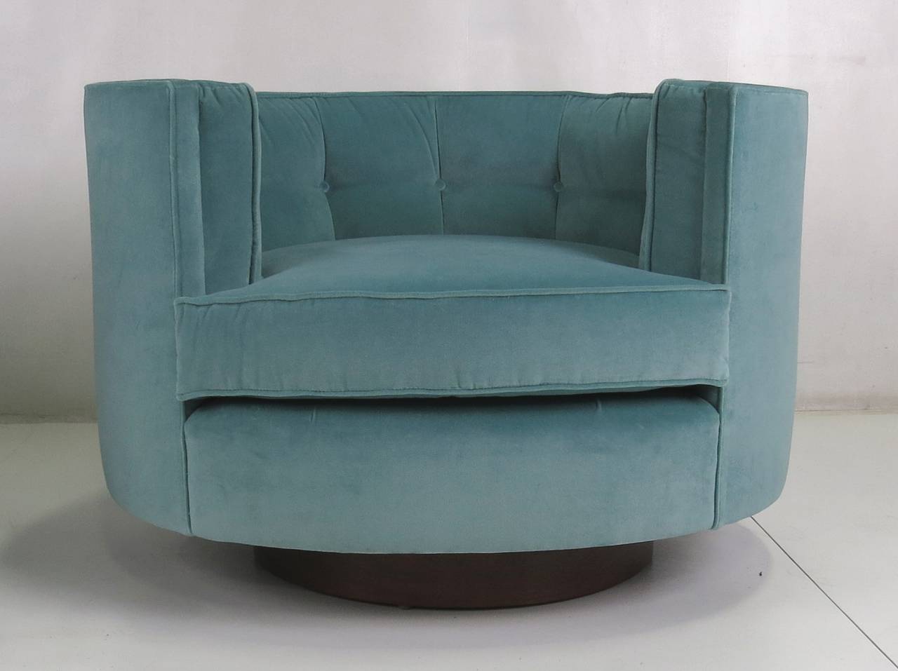 Gorgeous pair of Milo Baughman oval Swivel Lounge Chairs raised on a round Walnut swivel base. 