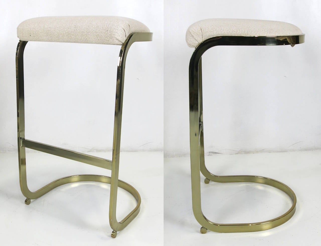 Nice pair of brass frame cantilevered seat barstools attributed to Milo Baughman.