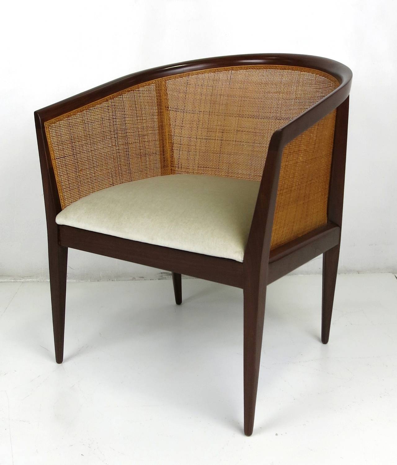 Superbly crafted caned back walnut lounge chair by Kipp Stewart for Directional. The chair has been meticulously restored to mint condition and reupholstered in luxurious heavyweight velvet.