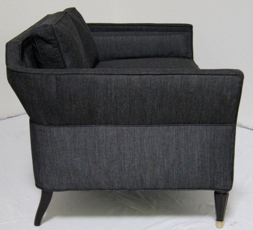 Shapely pair of Loveseats with flared arms and backs by Baker for Marshall Field's.  The legs are scalloped and tapered with brass sabots.  The pair have been freshly refinished and reupholstered.