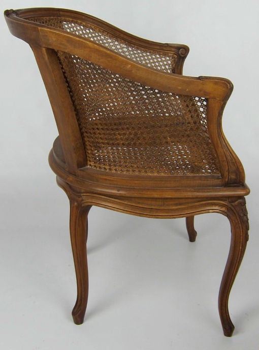 Beautifully carved Louis XV style Bergere with caned seat and back.  Probably Italian in origin.