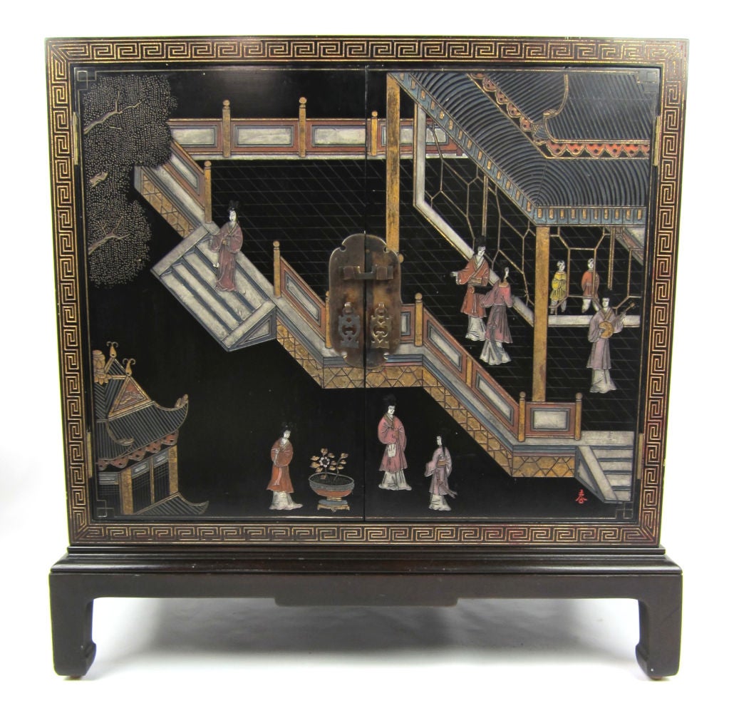 Exceptional Coromandel Lacquer Cabinet with incised figural scene on doors and gilt Greek Key border on all sides and top.  One adjustable interior shelf and Oriental brass hardware.  This versatile piece will work as a bar cabinet, small