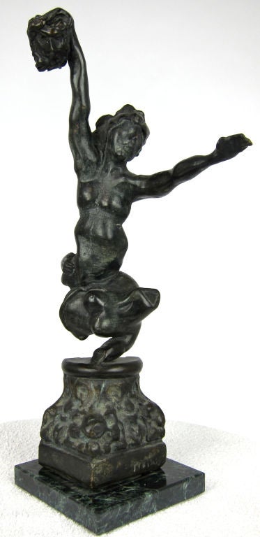 Solid bronze figural sculpture on an architectural fragment plinth. Mounted on a Negro Marquina marble base. Signed 