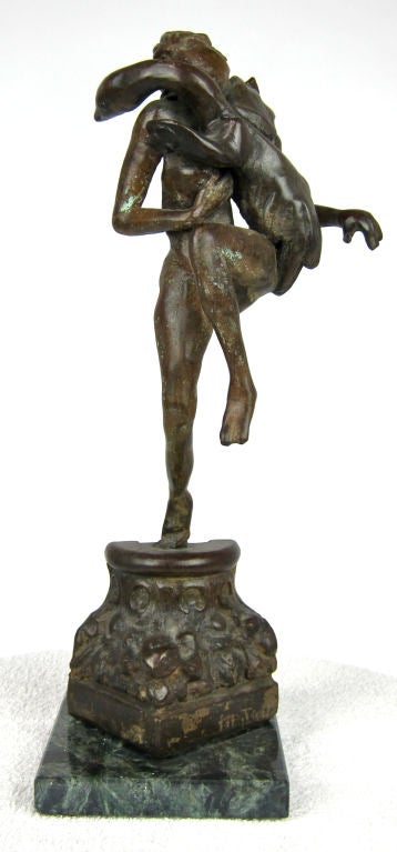 Solid bronze figural sculpture on an architectural fragment plinth.  Mounted on a Negro Marquina marble base.  Signed 