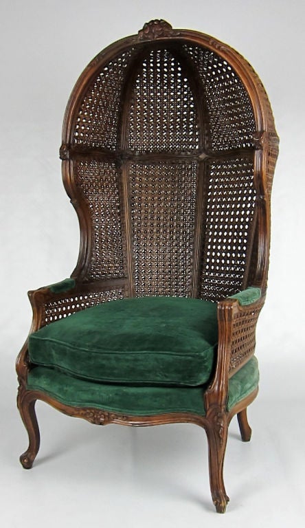 Beautifully carved Louis XV style Porter's chair, hand caned on the inside and outside of the frame.  Green velvet upholstery is in very good condition.
