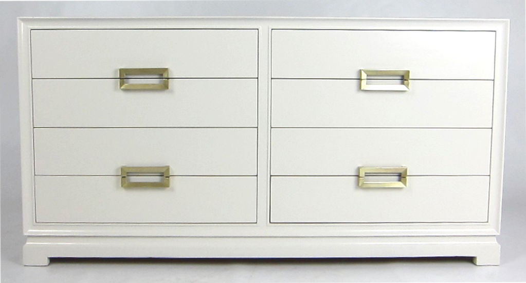 Deco Moderne dresser refinished in white lacquer with brushed brass hardware in the style of Tommi Parzinger.