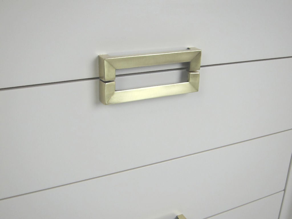 white dresser with brass hardware