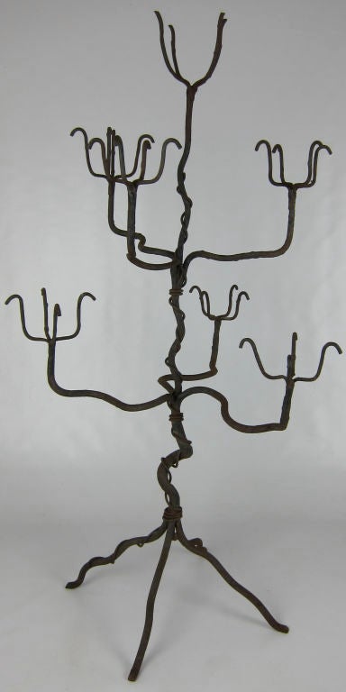 Beautifully detailed and constructed Artisan made Wrought Iron Tree form Candle stand.  The base and trunk are wrought with bark like striations along with wrapped vines and branch-like candle or pot holders.  Evocative of works by Giacometti