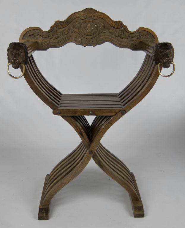 Set of six fine Italian Savonarola Chairs.  Folding Curule form frames feature carved Lion Head arms and intricately carved seatbacks.  These are the chicest folding chairs ever. Matching table is also available.