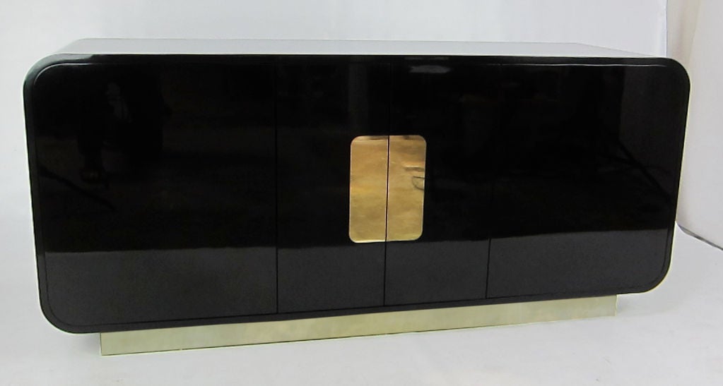 Classic 80's..clean lined and glamorous Custom Lacquer Cabinet with inset brass pushplates much like designs by Karl Springer or Pace.  Very high quality construction with Brass clad plinth base.  Matching 5' Bar Cabinet available.