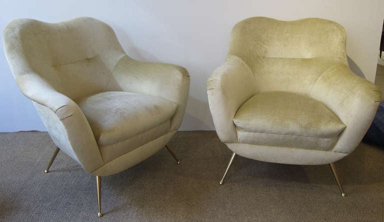 Pair of 1950's Italian lounge chairs, upholstered in light yellow velvet, splayed brass legs. Newly restored to perfection.

This item is located in Manhattan at 1stdibs@nydc showroom.  200 Lexington Ave.  10th Floor, NYC.