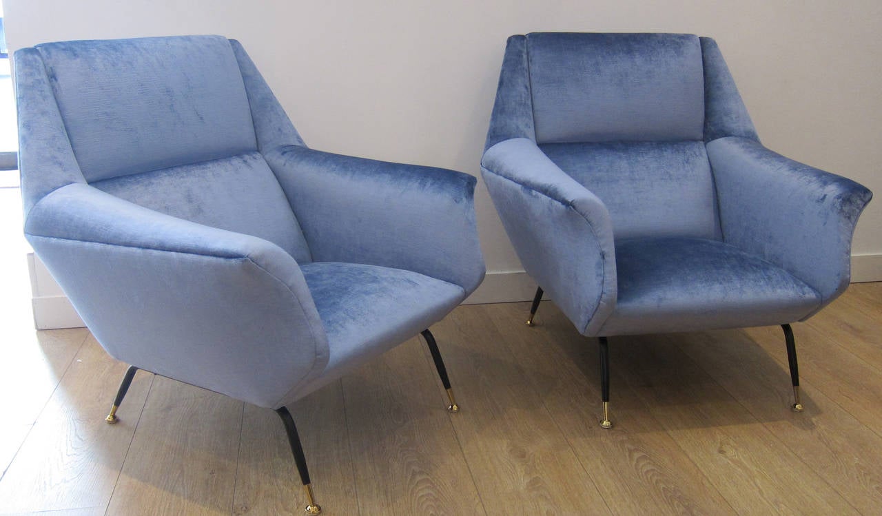 Pair of Italian 1950s armchairs, newly upholstered in velvet. Raised on four brass and black enameled legs. Faceted form sides with superb angular lines.