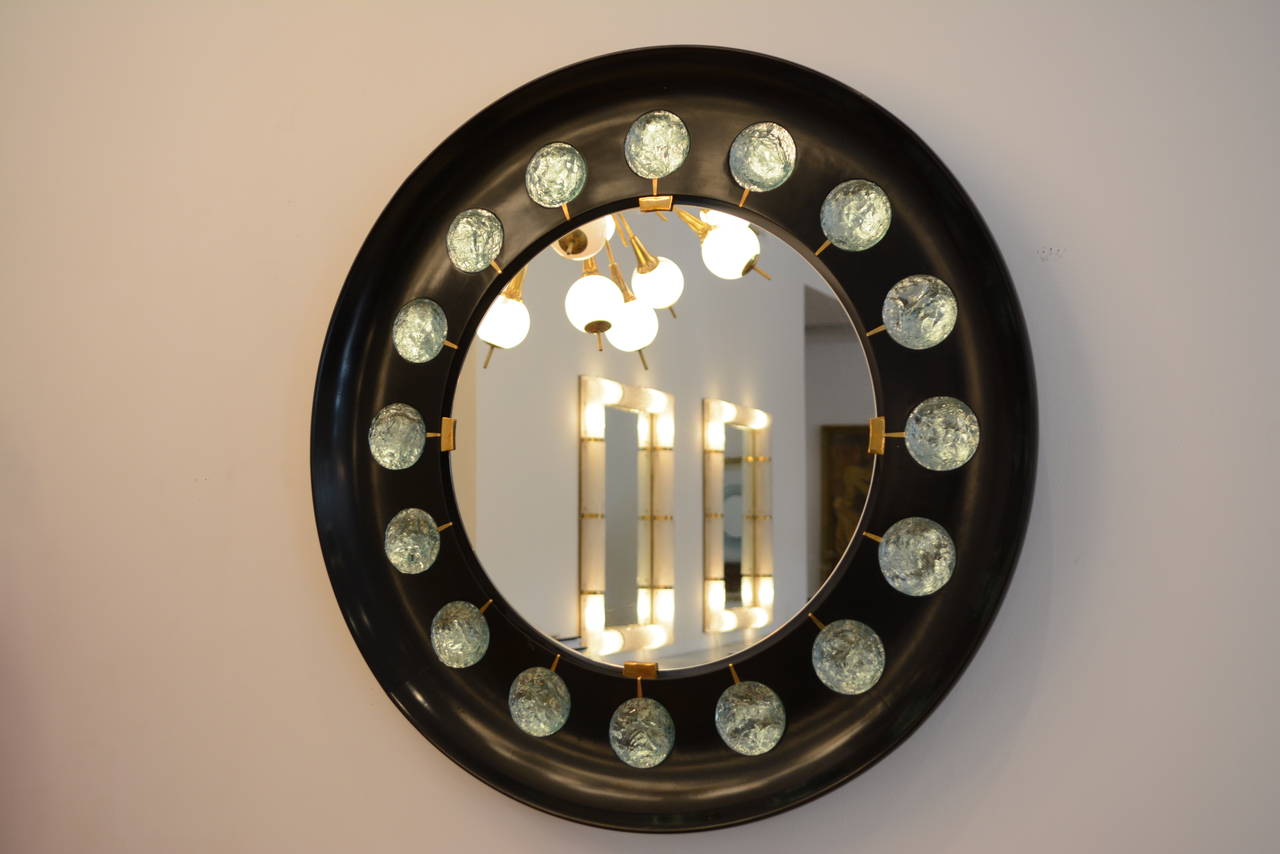 Contemporary wall mirror by Ghiro Studio.
16 hand-cut convex glass block, black concave wood frame with brass mounts. 
Signed.