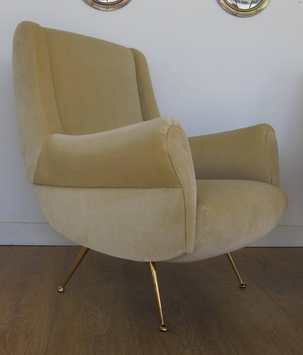 Superb pair of Italian lounge chairs, circa 1950. Newly upholstered with velvet, brass plated legs. All restored to perfection. Complimentary shipping to Continental US only.