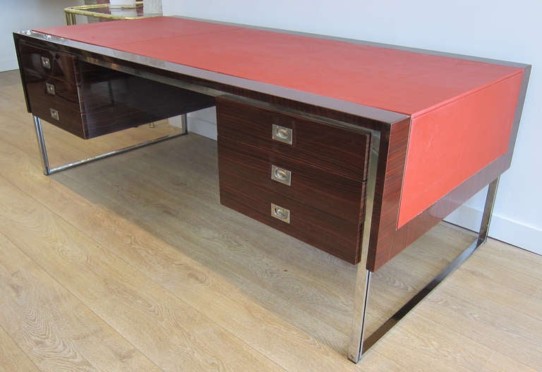 Impressive executive desk by De Coene Freres for Knoll International. One of a kind desk executed with ebony macassar veneered, chrome structure, red top leather. 6 drawers,2 with secret compartments and 2 with document organizer. 