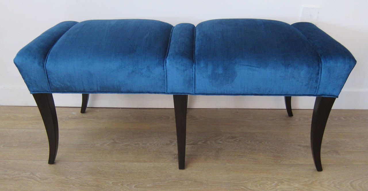 Pair of 1950s benches in the style of Tommi Parzinger, newly upholstered with a peacock blue velvet. Base is ebonised walnut.

