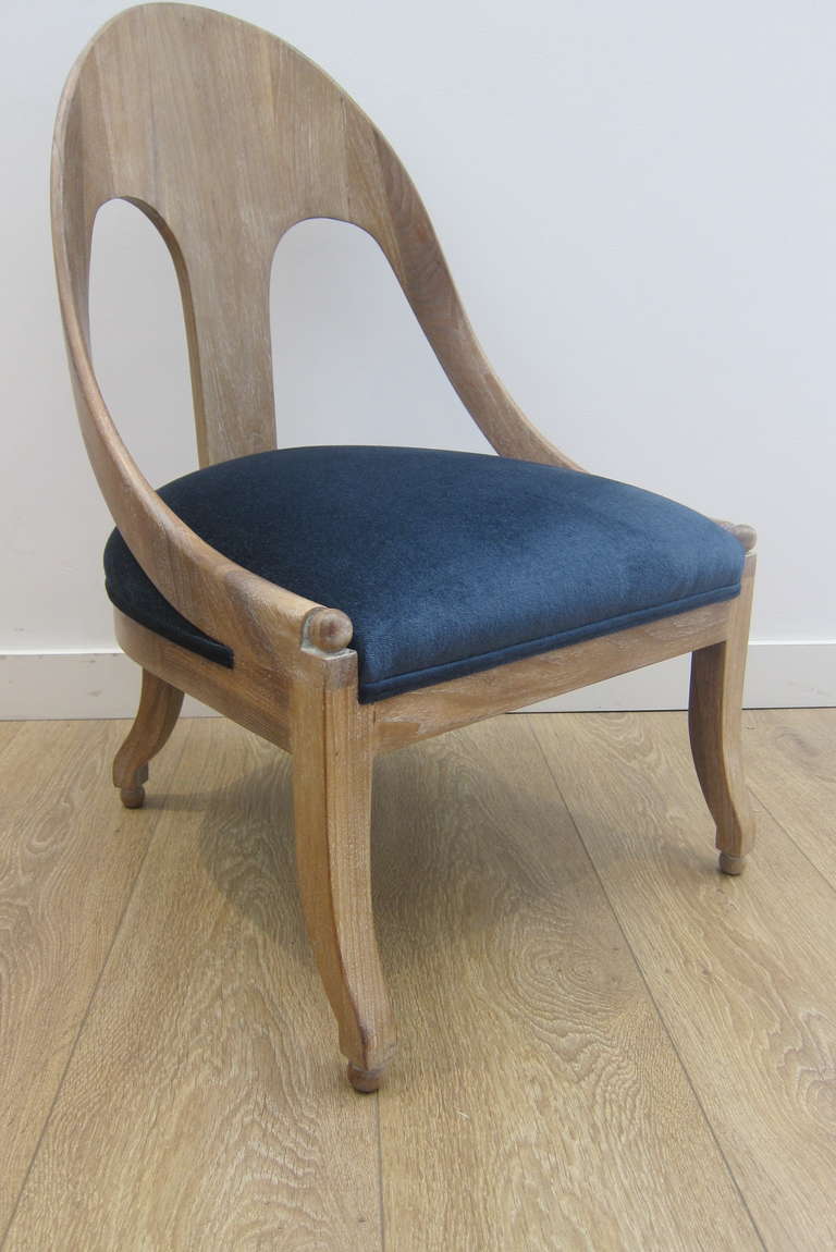 A vintage cerused finish spoon back chair newly upholstered with a blue velvet.