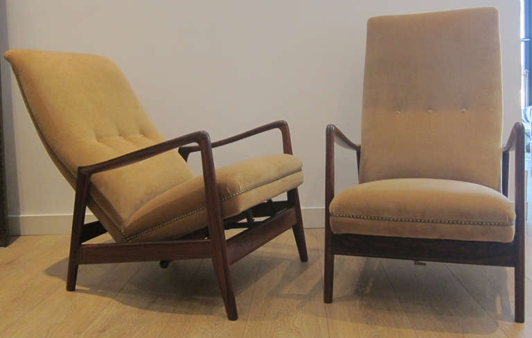These chairs lock into any reclining position for extra comfort and stability. Newly upholstered with caramel velvet and brass nails. Rosewood frame restored to original condition.