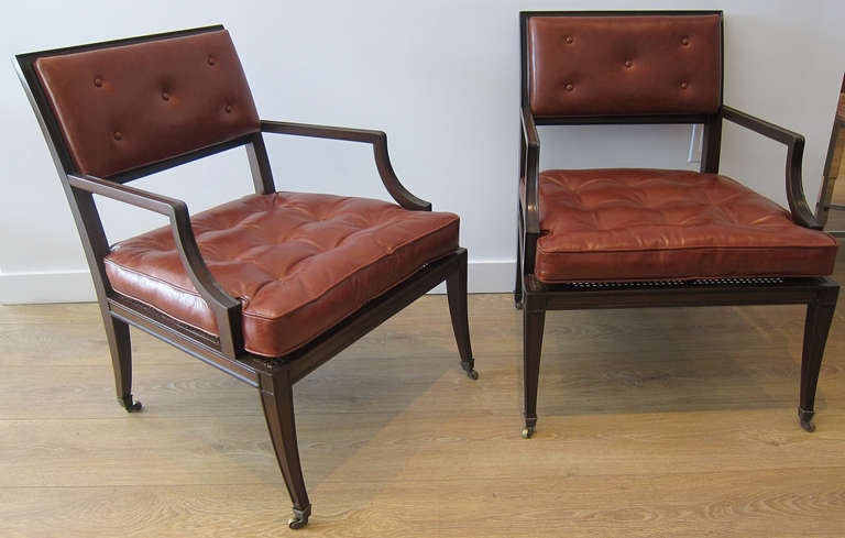 Pair of Regency style library armchairs, caned seat,  brass casters. Newly upholstered in tobacco leather, dark walnut finish. Great proportion.