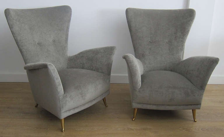 Pair of petite Italian lounge chairs. Exceptional lines, brass plated legs, newly upholstered with a gray cotton velvet. 
