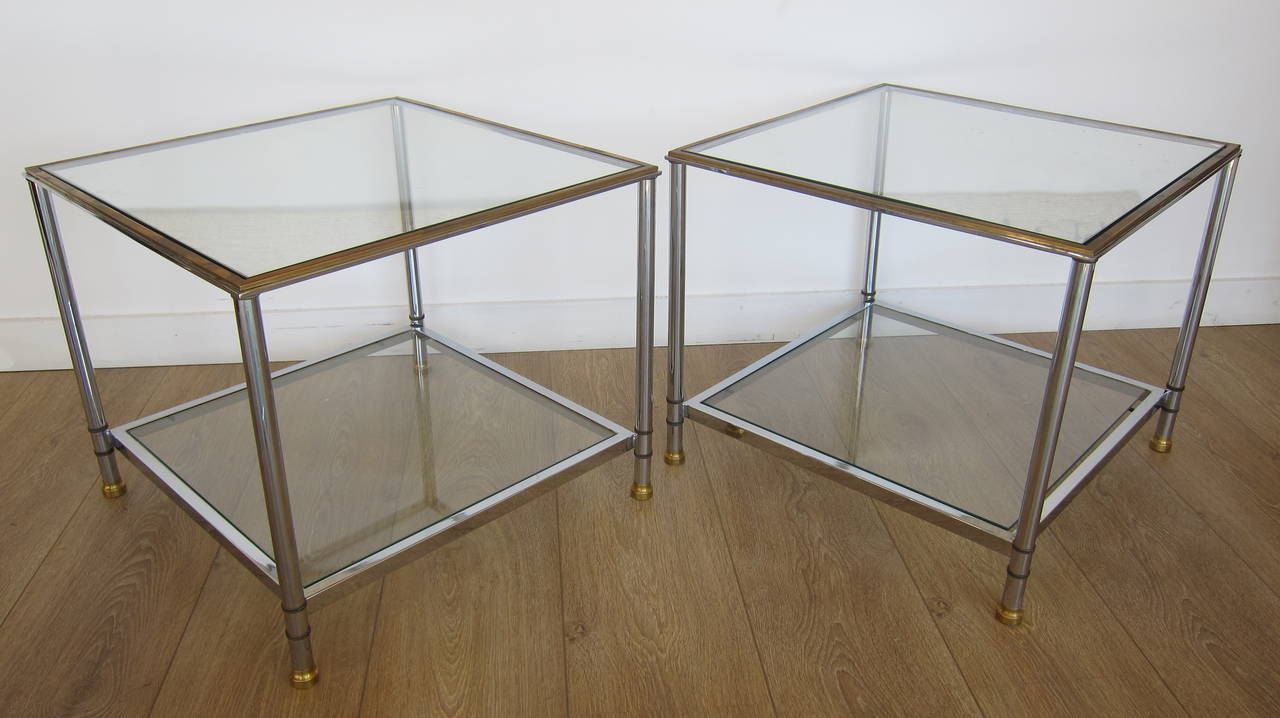 Pair of two tiers chrome and solid brass end tables, with clear inset class.
Solid brass sabots and gallery.