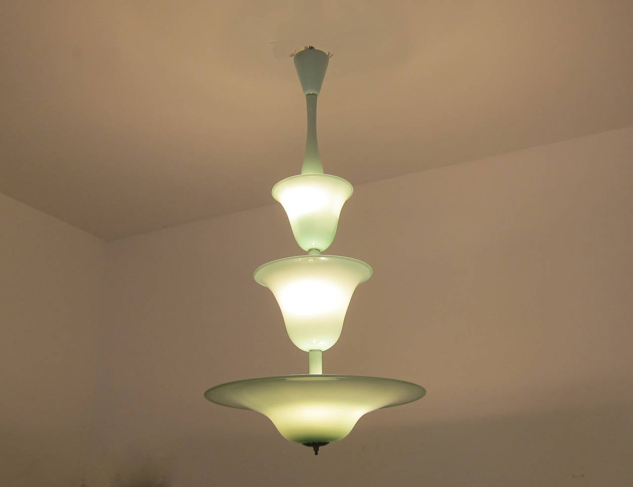 A rare three-tier celadon green Murano glass pendant by Venini. Newly rewired to American standard. Brass finial.