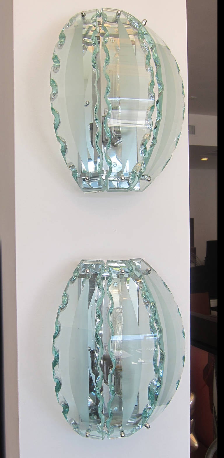Pair of wall sconces in the manner of Fontana Arte, chiseled green glass. Wired to the American standard, restored to perfection.